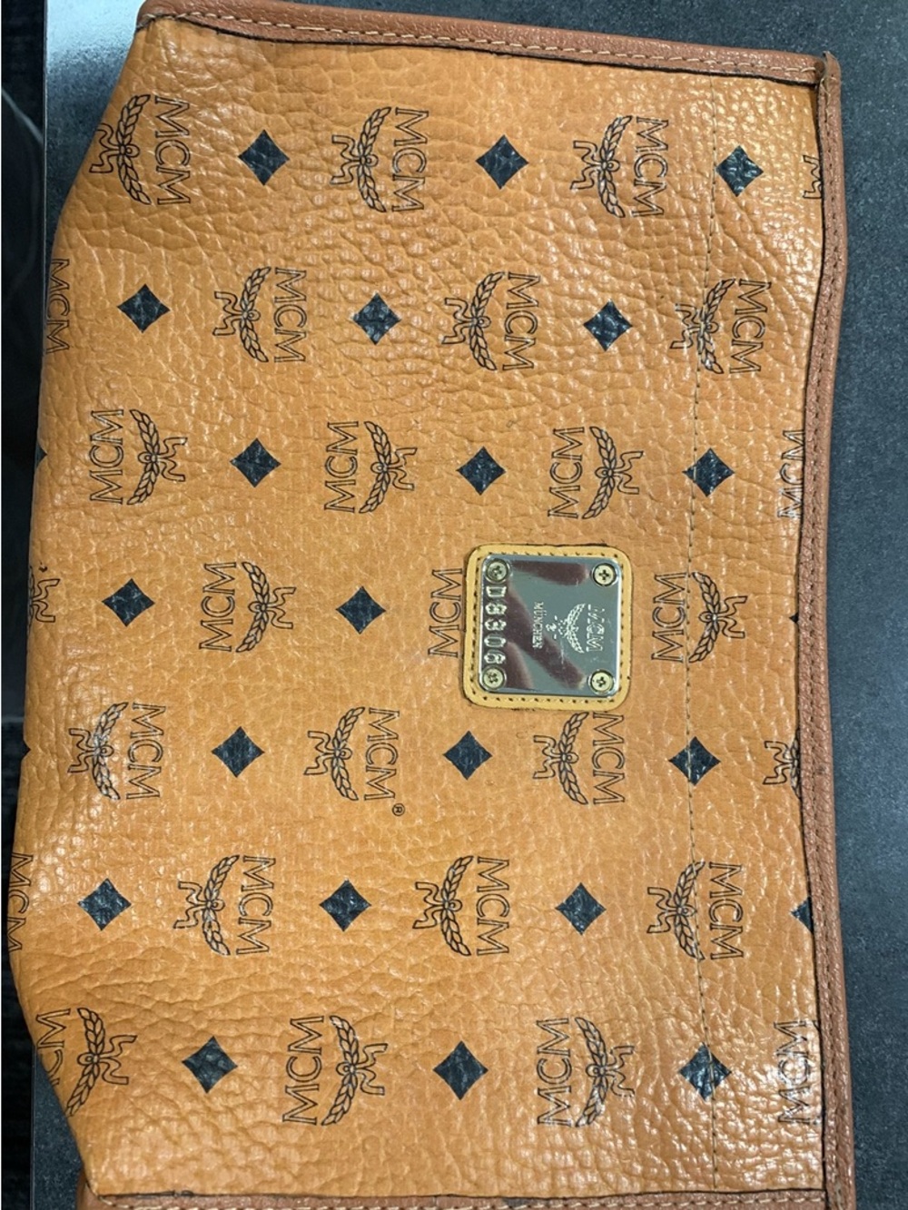 MCM Cognac and Black Visetos Monogram Pouch with Gold Plaque.